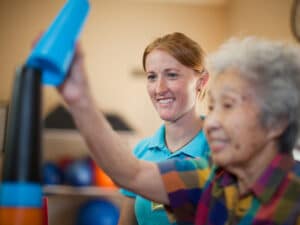 A physical therapist working with an elderly woman at Mckinley Park