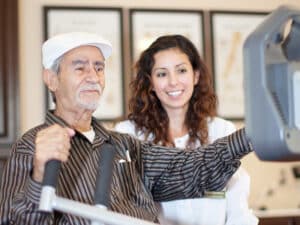 A physical therapist working with an elderly man at Mckinley Park