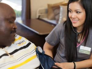 A nurse helping a man at Mckinley Park